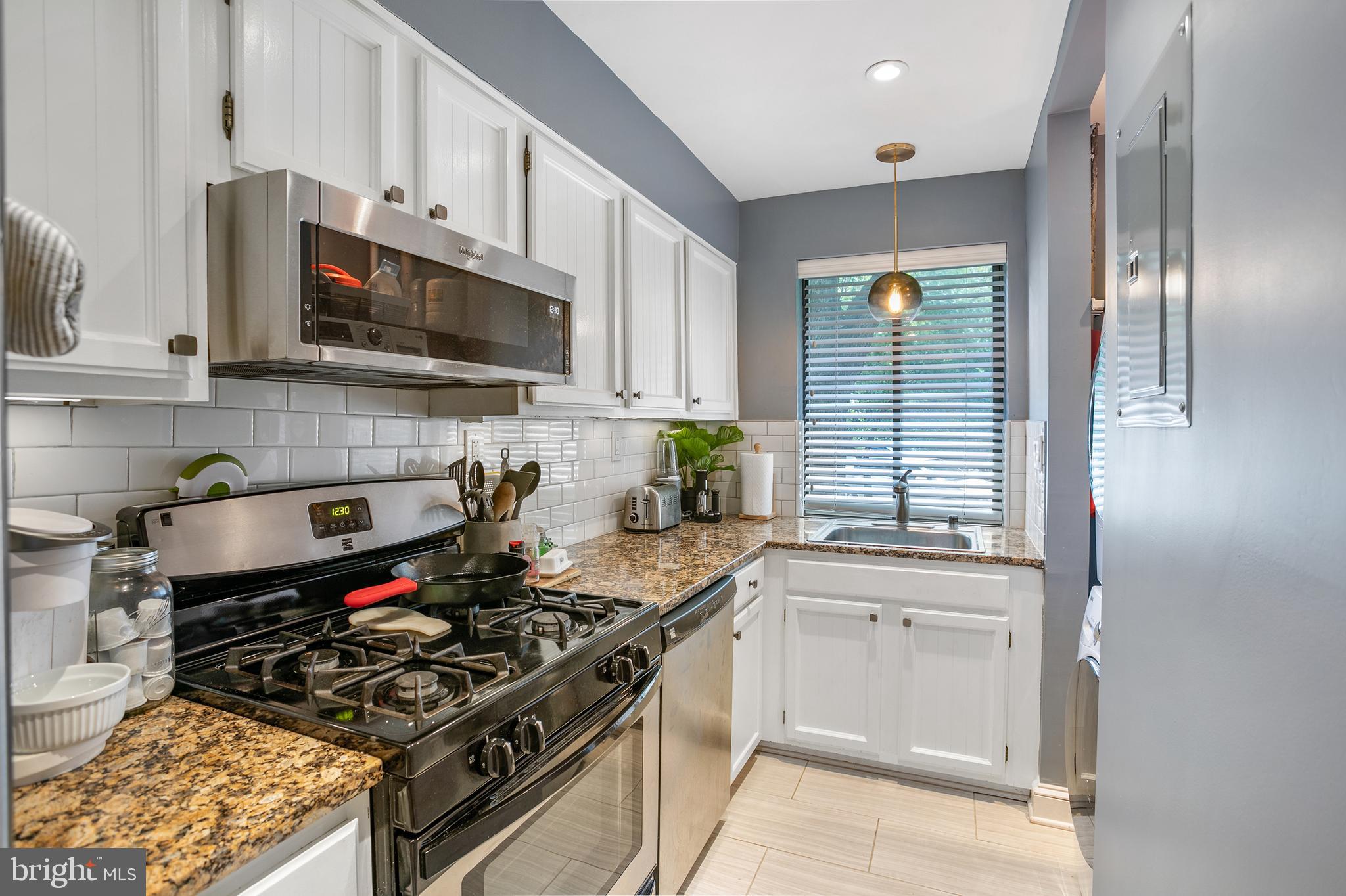 3817 Davis Place Northwest, Unit 2 Washington, DC 20007 - Photo 9 of 21 a kitchen with stainless steel appliances a sink a stove and cabinets