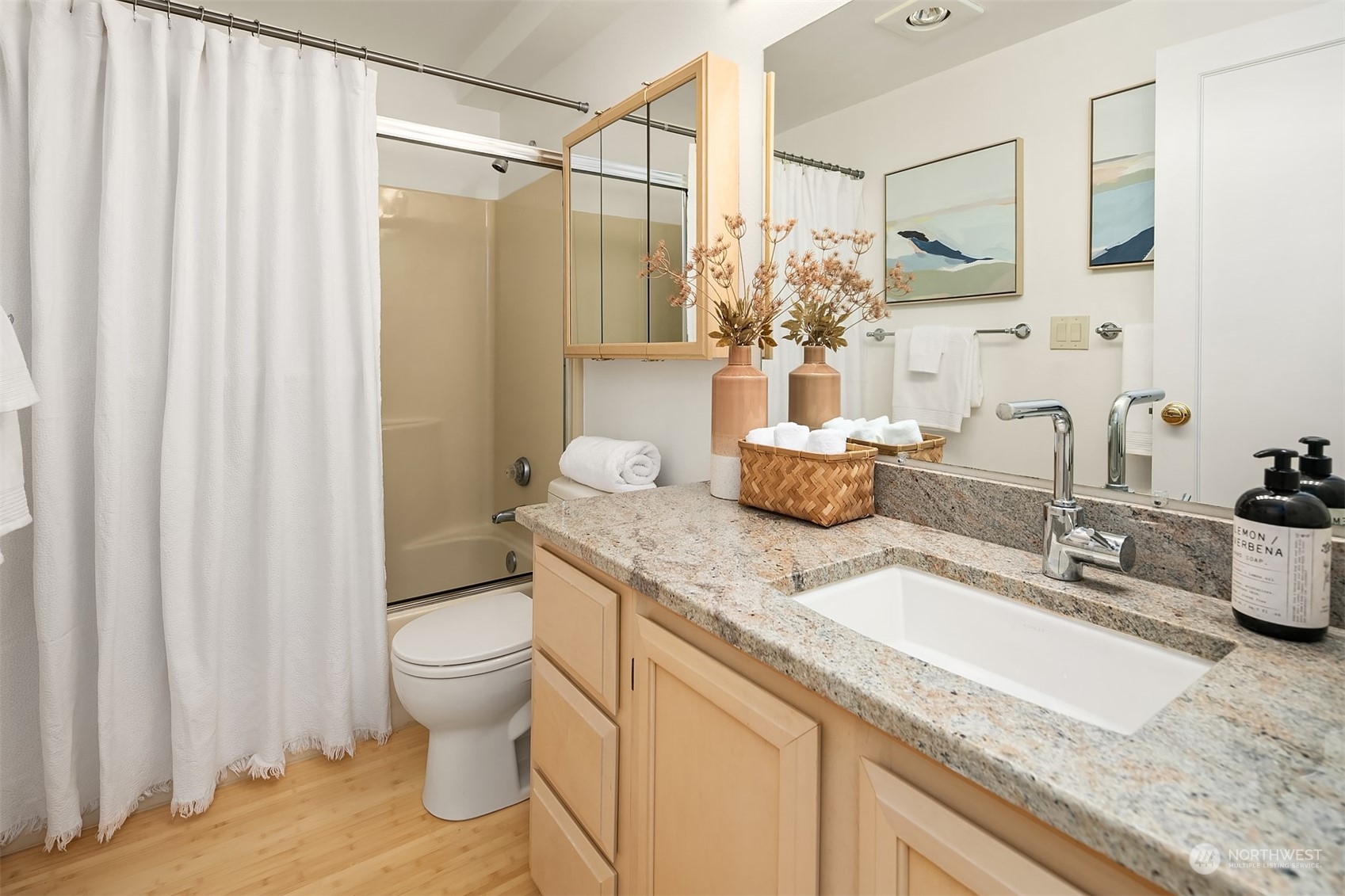 1110 West Howe Street, Unit 202 Seattle, WA 98119 - Photo 12 of 15 a bathroom with a granite countertop sink and a mirror