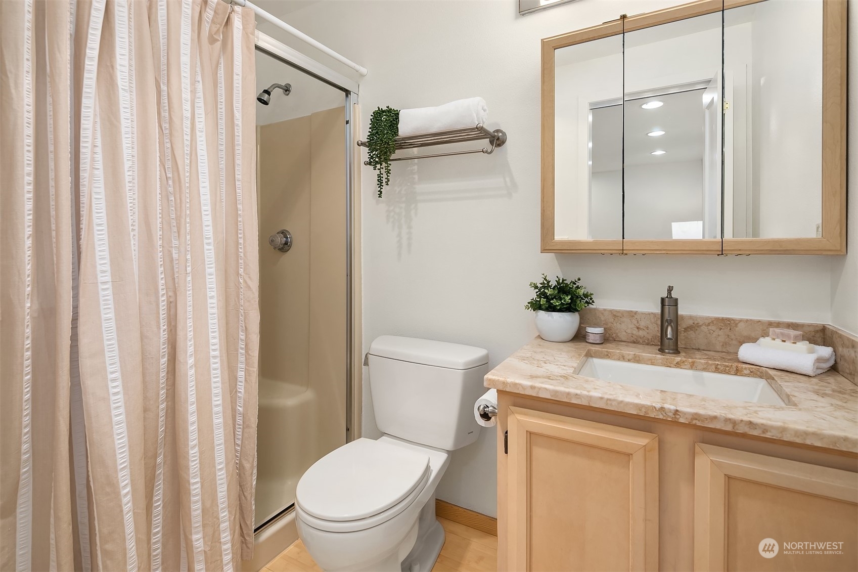 1110 West Howe Street, Unit 202 Seattle, WA 98119 - Photo 14 of 15 a bathroom with a granite countertop sink toilet and shower