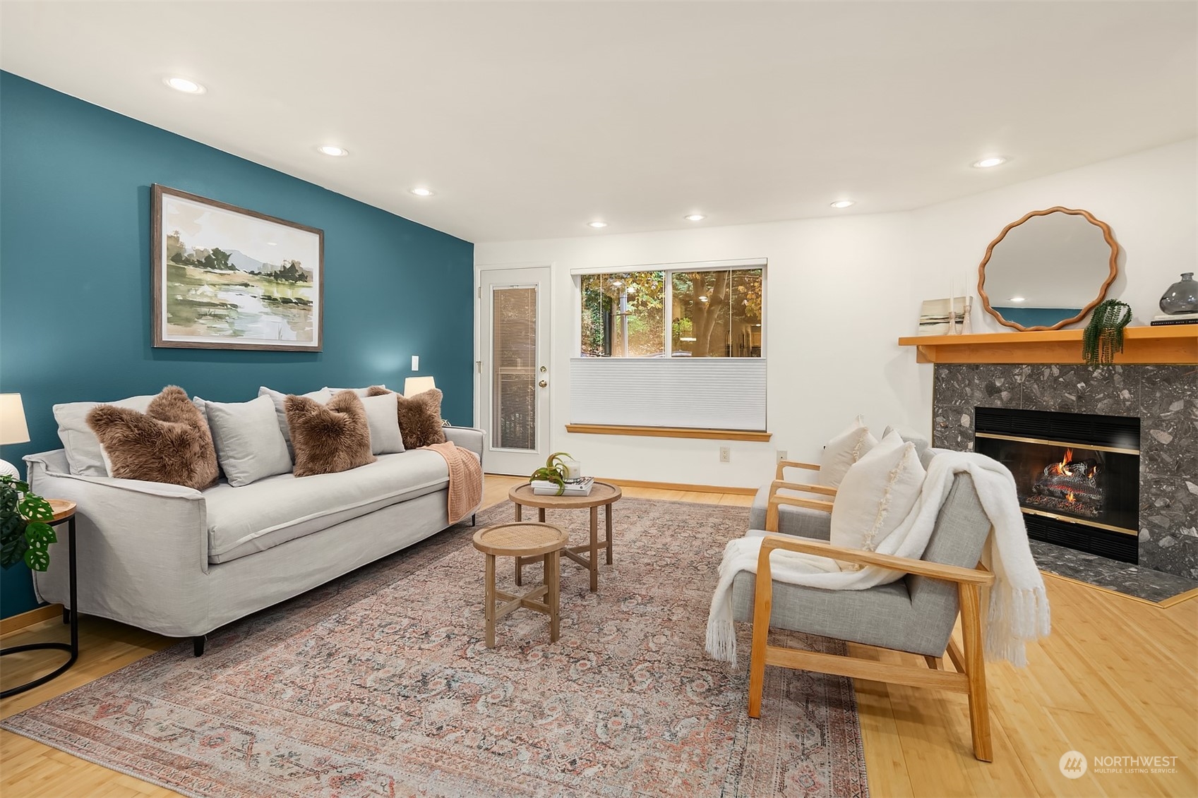 1110 West Howe Street, Unit 202 Seattle, WA 98119 - Photo 2 of 15 a living room with furniture and a fireplace