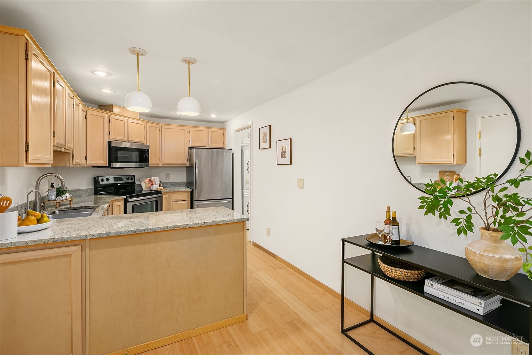 1110 West Howe Street, Unit 202 Seattle, WA 98119 - Photo 7 of 15 a kitchen with stainless steel appliances granite countertop a sink a stove and a wooden floors
