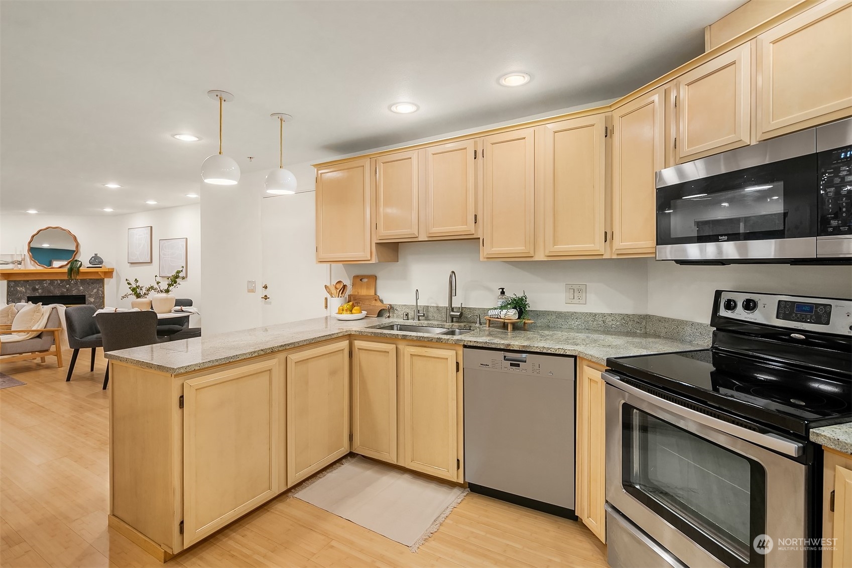 1110 West Howe Street, Unit 202 Seattle, WA 98119 - Photo 8 of 15 a kitchen with a sink a microwave and cabinets