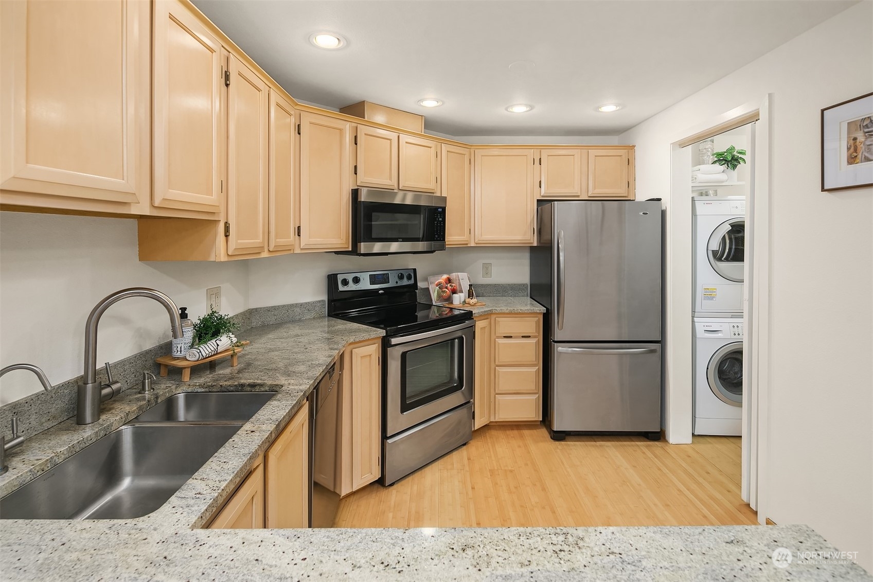 1110 West Howe Street, Unit 202 Seattle, WA 98119 - Photo 9 of 15 a kitchen with refrigerator a microwave a sink and cabinets