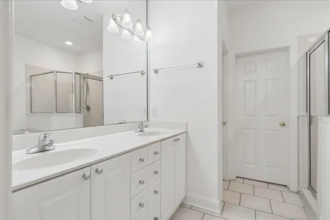 a bathroom with a granite countertop sink a mirror and a vanity