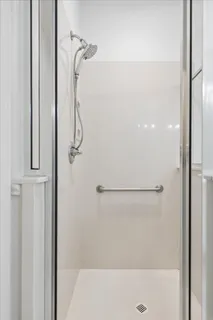 a bathroom with a glass shower door