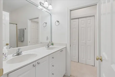 a bathroom with a double vanity sink and mirror
