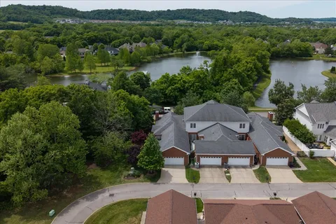 an aerial view of a house with garden space and lake view