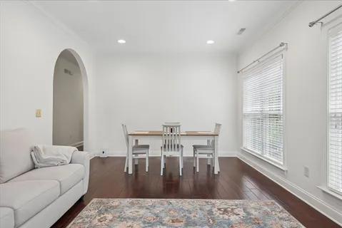 a living room with furniture wooden floor and a table