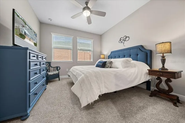 a bedroom with a bed furniture a chandelier and a window