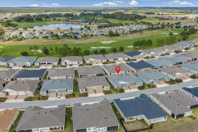 an aerial view of a city with lots of residential buildings and mountain view in back