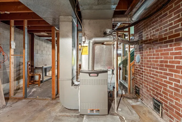 a view of house with outdoor seating area and trees
