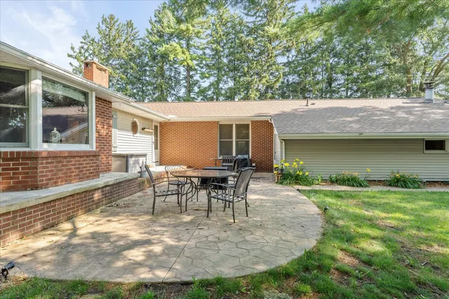 a view of a backyard with a patio and a garden