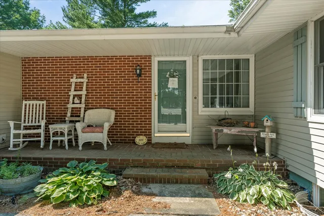 a view of a patio with table and chairs and potted plants