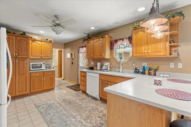 a kitchen with a sink appliances cabinets and a counter top space