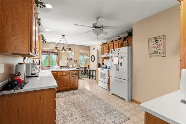 a kitchen with stainless steel appliances kitchen island granite countertop a refrigerator and a stove top oven