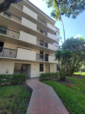 a front view of a building with garden