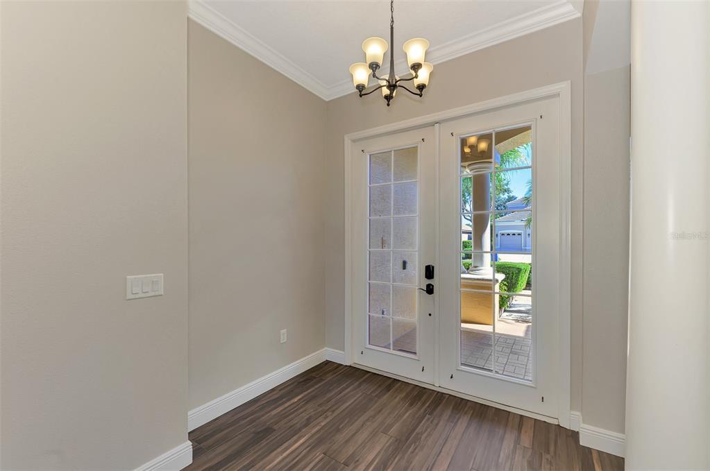 6610 Coopers Hawk Court Lakewood Ranch, FL 34202 - Photo 14 of 97 a view of empty room with wooden floor and fan