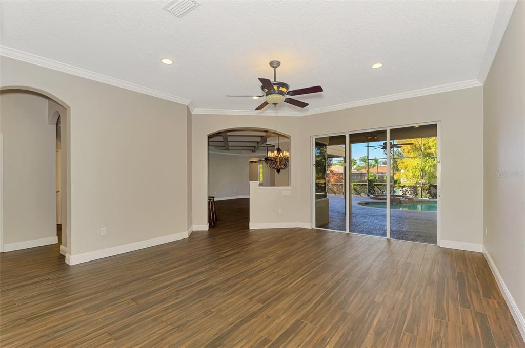 6610 Coopers Hawk Court Lakewood Ranch, FL 34202 - Photo 16 of 97 a view of an empty room with wooden floor and a window