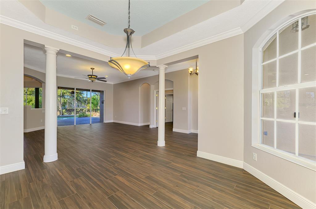 6610 Coopers Hawk Court Lakewood Ranch, FL 34202 - Photo 23 of 97 a view of an empty room with wooden floor and a window