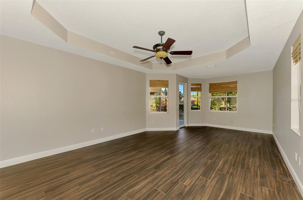 6610 Coopers Hawk Court Lakewood Ranch, FL 34202 - Photo 40 of 97 an empty room with wooden floor and windows