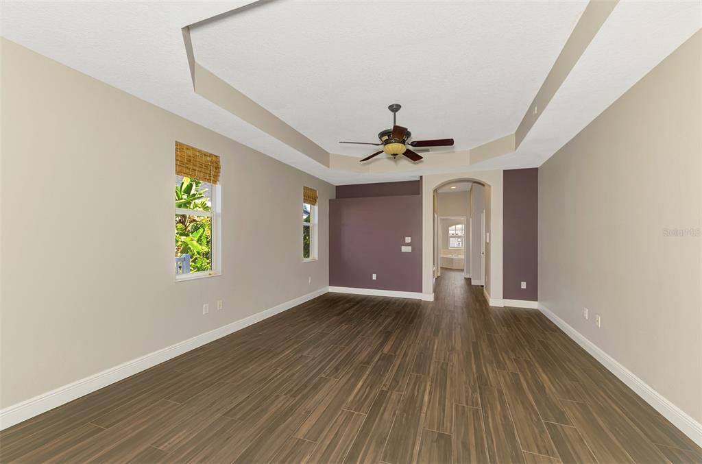 6610 Coopers Hawk Court Lakewood Ranch, FL 34202 - Photo 42 of 97 a view of an empty room with window and wooden floor