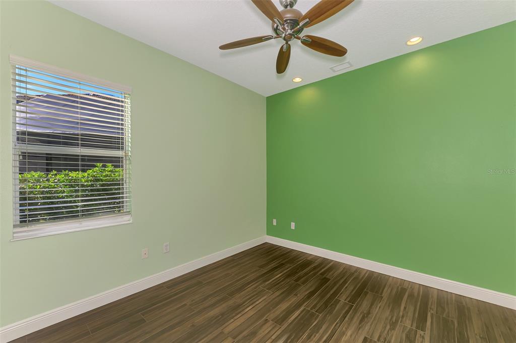 6610 Coopers Hawk Court Lakewood Ranch, FL 34202 - Photo 53 of 97 a view of a big room with wooden floor closet and windows