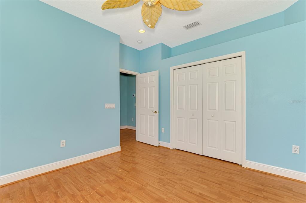 6610 Coopers Hawk Court Lakewood Ranch, FL 34202 - Photo 63 of 97 a view of an empty room with wooden floor