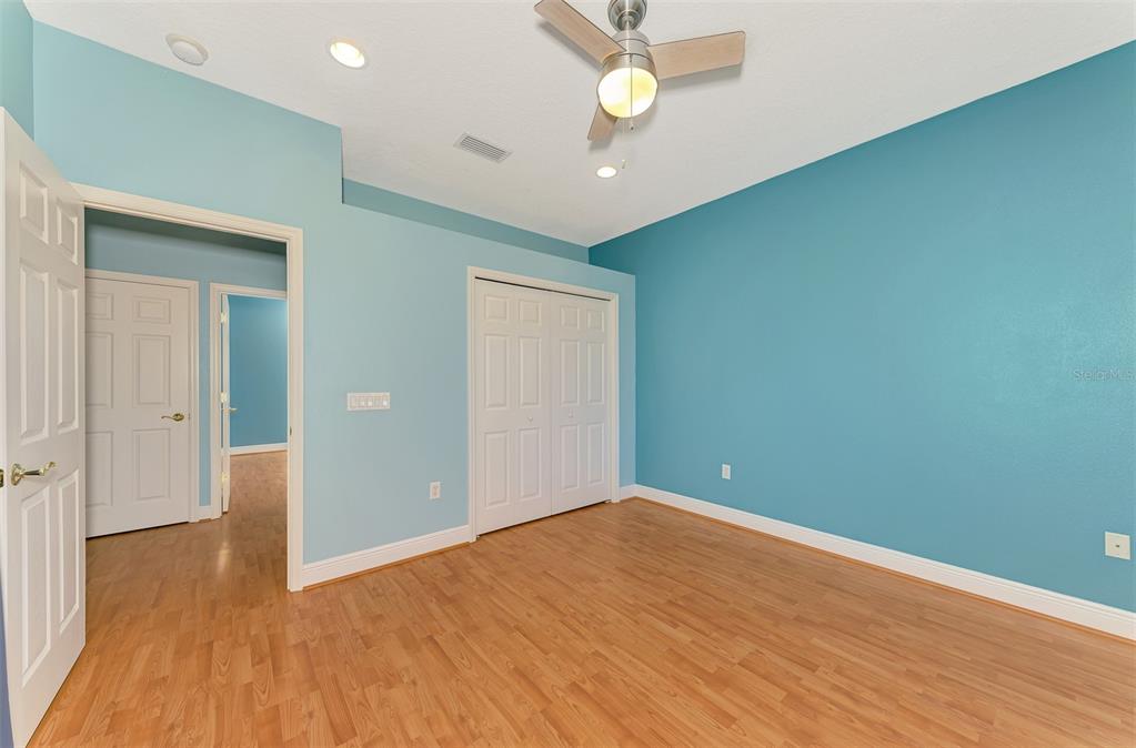 6610 Coopers Hawk Court Lakewood Ranch, FL 34202 - Photo 65 of 97 an empty room with wooden floor and windows