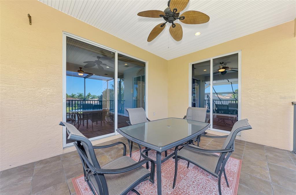6610 Coopers Hawk Court Lakewood Ranch, FL 34202 - Photo 67 of 97 a view of a dining room with furniture and a chandelier fan