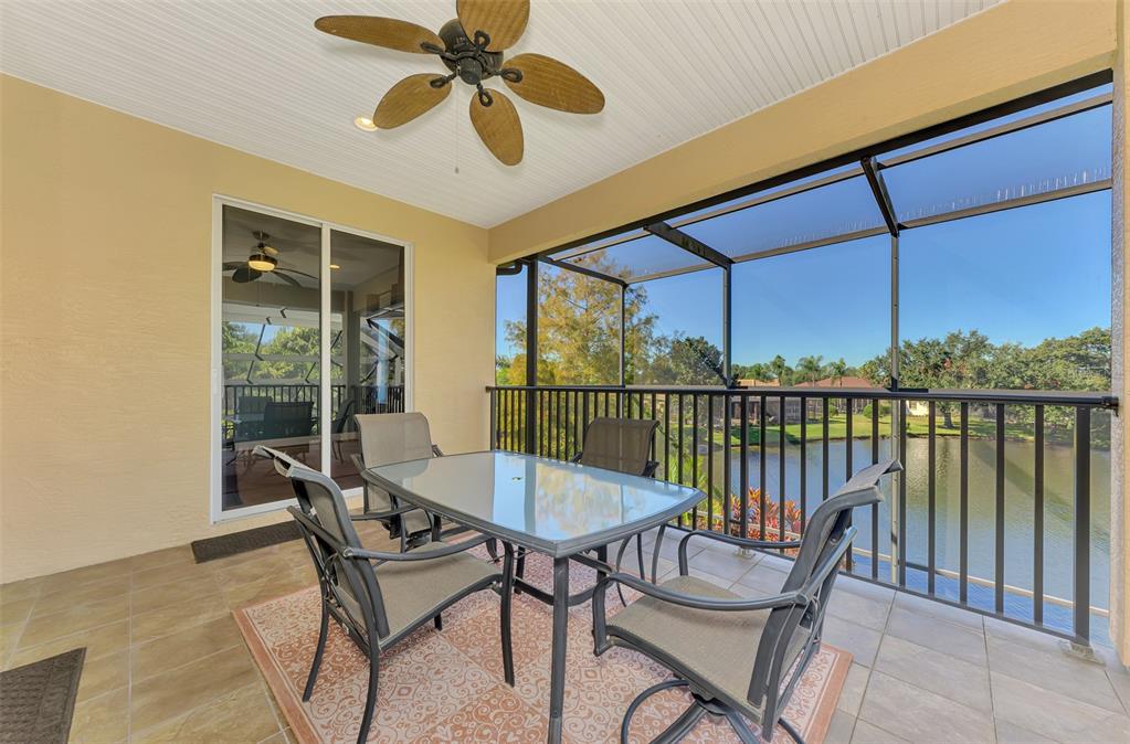 6610 Coopers Hawk Court Lakewood Ranch, FL 34202 - Photo 68 of 97 a view of a balcony with furniture and a floor to ceiling window