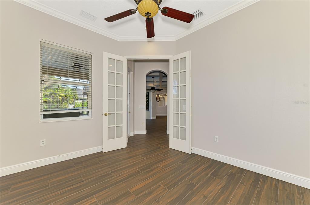 6610 Coopers Hawk Court Lakewood Ranch, FL 34202 - Photo 72 of 97 a view of an empty room with wooden floor and a window