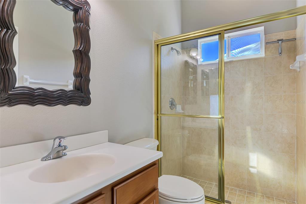 6610 Coopers Hawk Court Lakewood Ranch, FL 34202 - Photo 73 of 97 a bathroom with a sink a toilet and shower