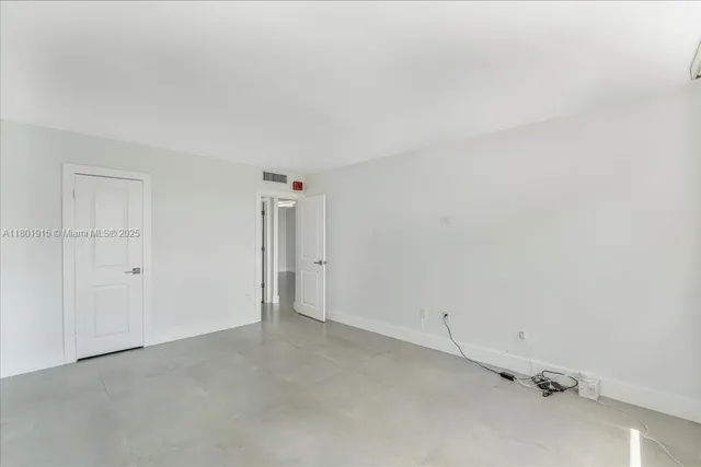 a view of a hallway with wooden floor and stairs