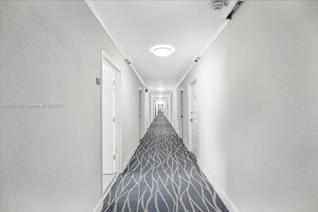 a view of an empty room with a window and storage