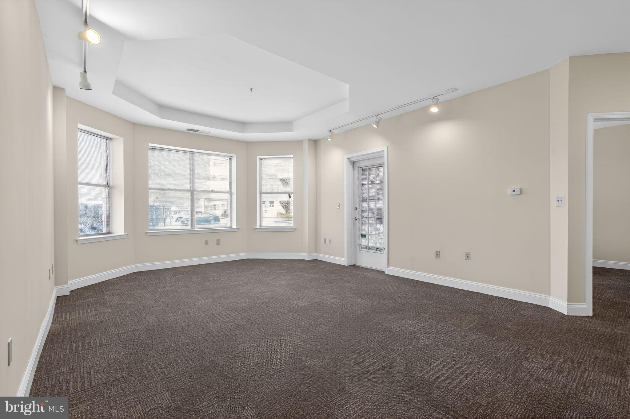 an empty room with windows and closet