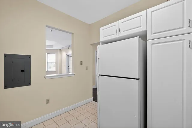a white refrigerator freezer sitting inside of a kitchen