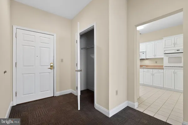 a view of a kitchen with white cabinets and sink