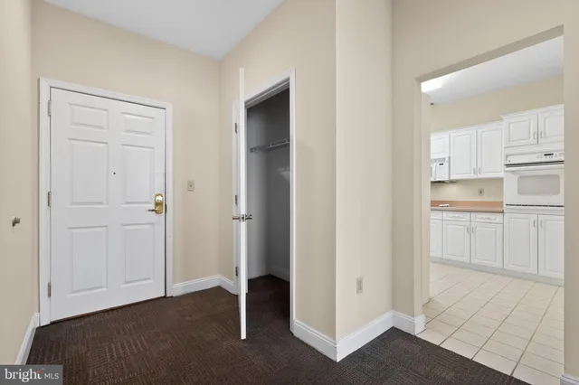 a view of a kitchen with white cabinets and sink