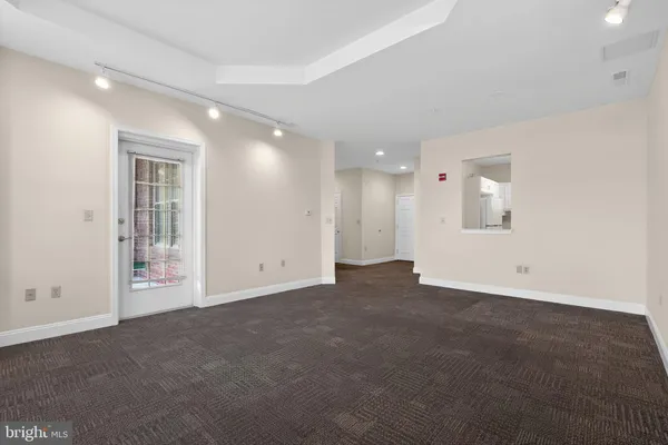 an empty room with a empty space and windows