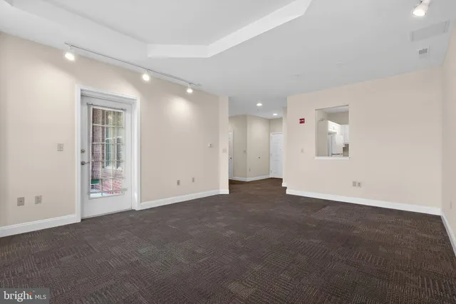 an empty room with a empty space and windows