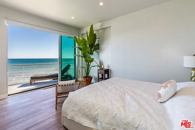 a view of a city from a balcony with furniture