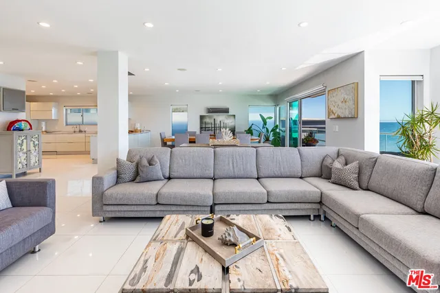 a view of a living room kitchen and a large window