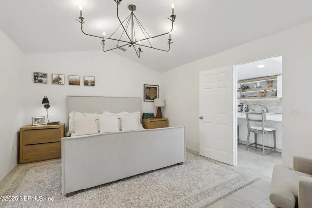 a living room with furniture and view of kitchen