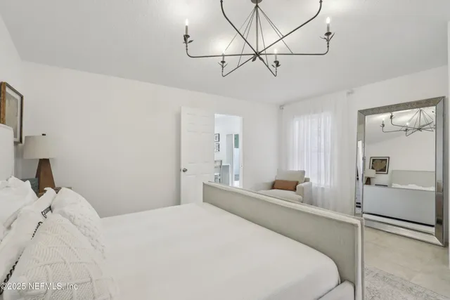a bedroom with a large bed and ceiling fan