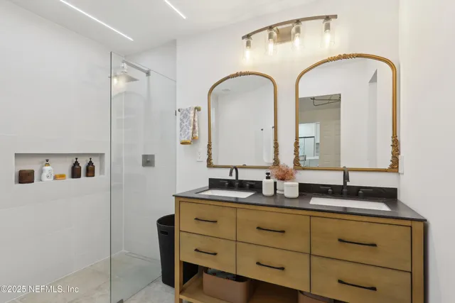 a bathroom with a double vanity sink and mirror