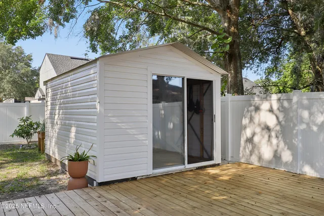 a view of a house with a backyard and porch