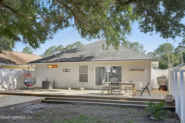 a view of a backyard with plants and a tree
