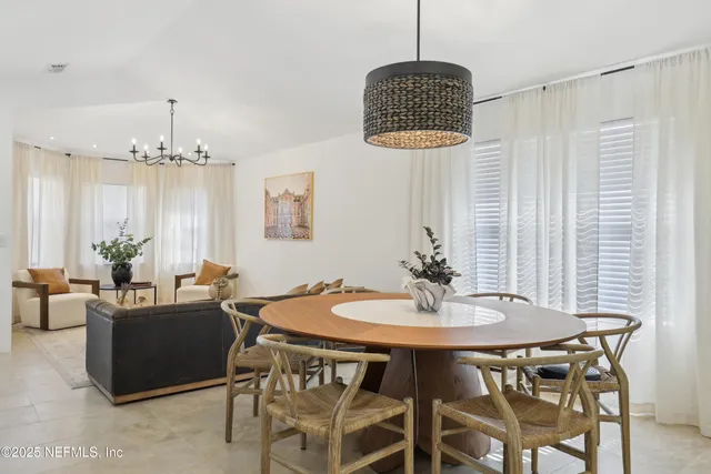 a view of a dining room with furniture wooden floor and chandelier