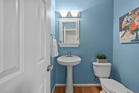 a view of a hallway with a livingroom and stairs