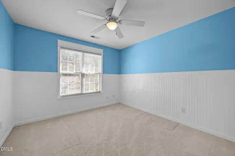 a view of a livingroom with a ceiling fan and window